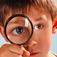 Boy with magnifying glass photo